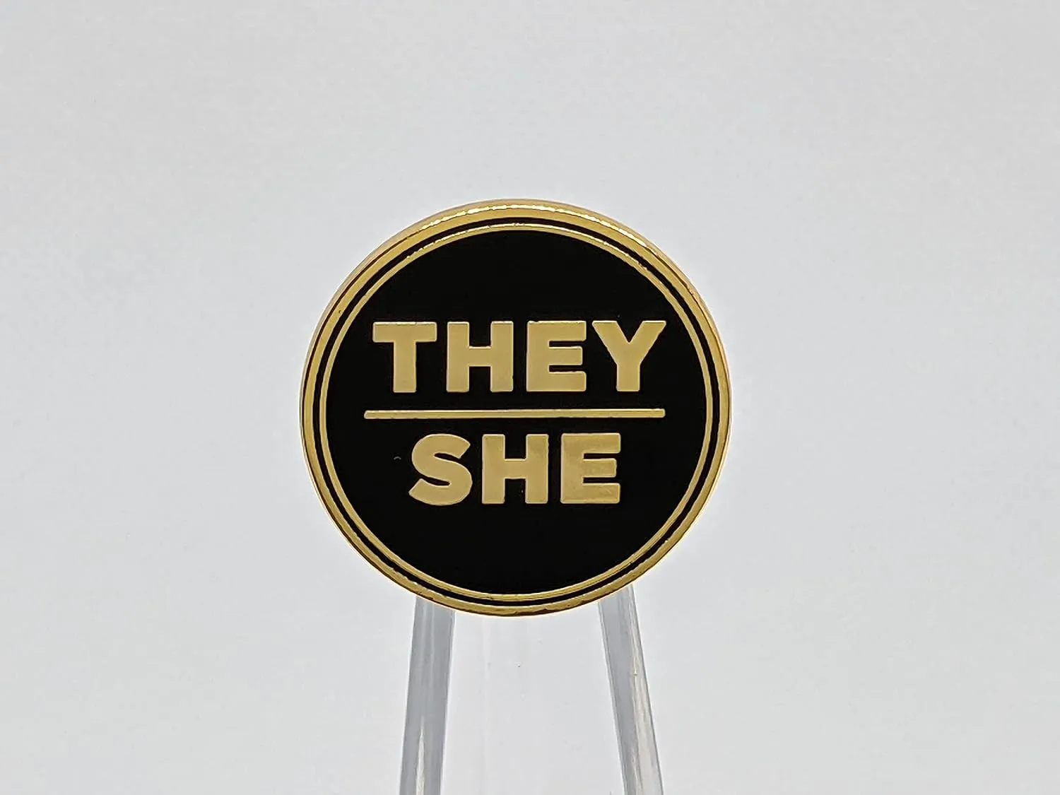 They She Black and Gold Circular Hard Enamel Pronoun Pin | Nonbinary Femme Pronoun Button Badge